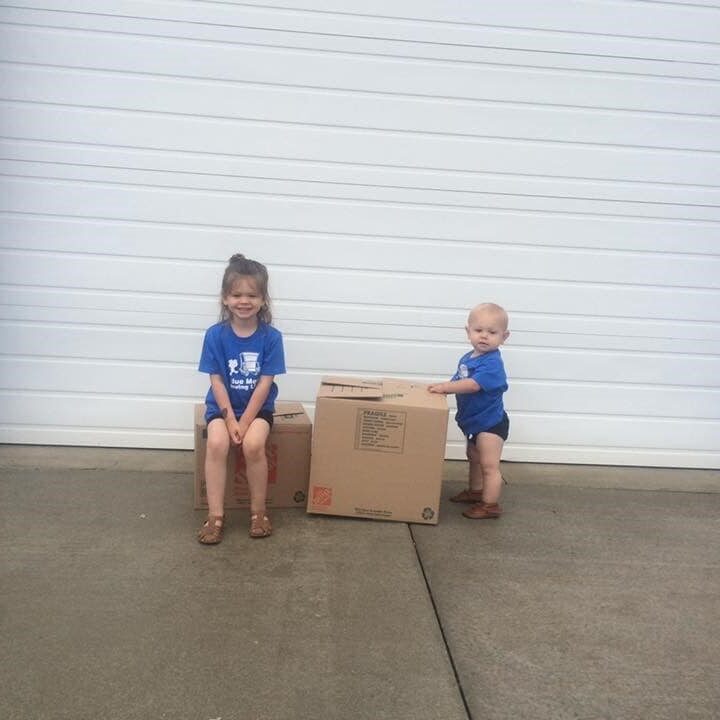 Blue Men Moving - Kids sitting on moving boxes